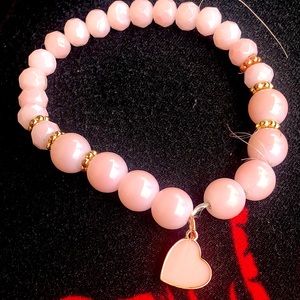 A pink heart bracelet with gold
